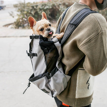 Dog carrier backpack carrying a small French Bulldog on a person's back, ideal for portable pet travel with PawTrek™.